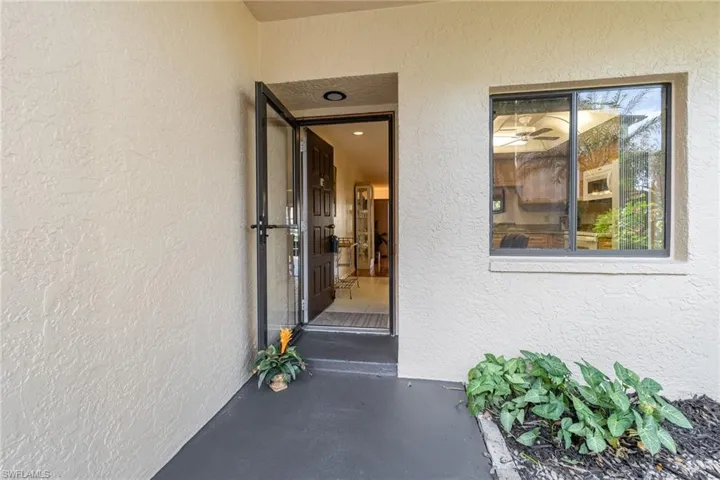 Property entrance featuring stucco siding