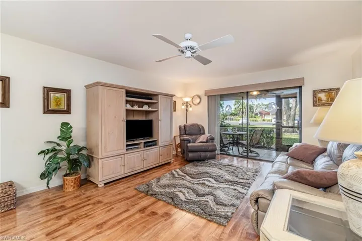 Living room featuring ceiling fan, and light wood-style floors