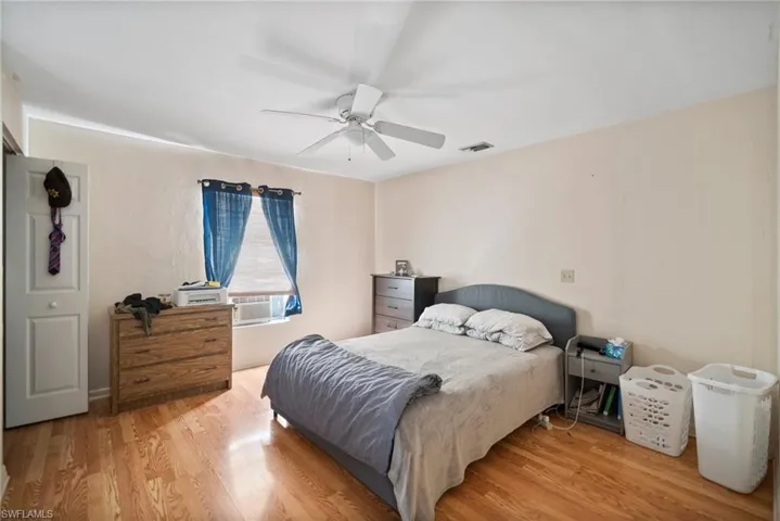 Bedroom featuring wood-type flooring and ceiling fan