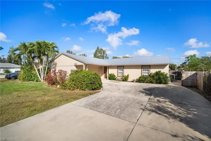 Ranch-style home featuring a front lawn