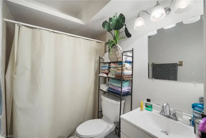 Bathroom with vanity, toilet, and walk in shower