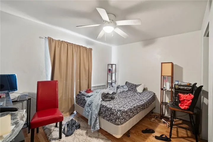 Bedroom featuring wood-type flooring and ceiling fan