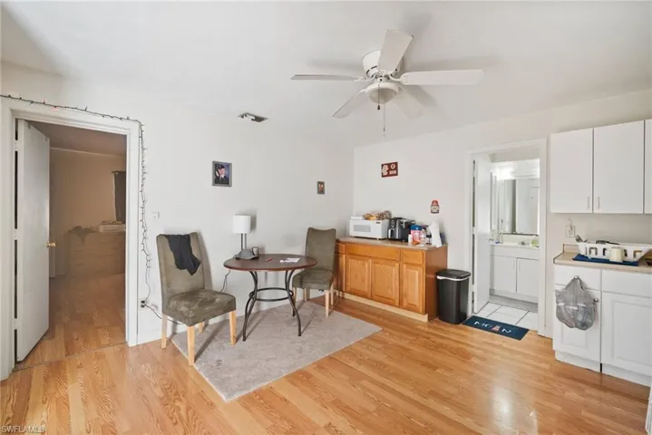 Sitting room with ceiling fan and light wood-type flooring