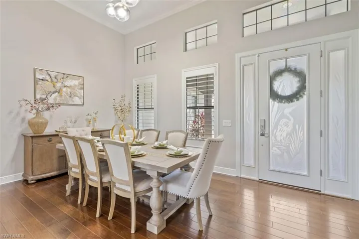 Dining room featuring dark hardwood / wood-style floors and crown molding
