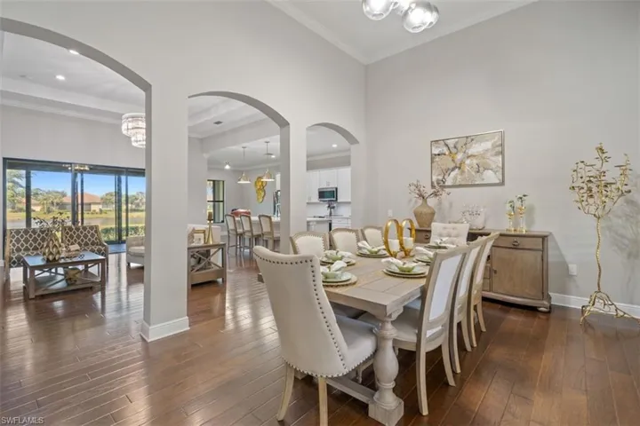 Dining area featuring a chandelier, dark hardwood / wood-style floors, and ornamental molding