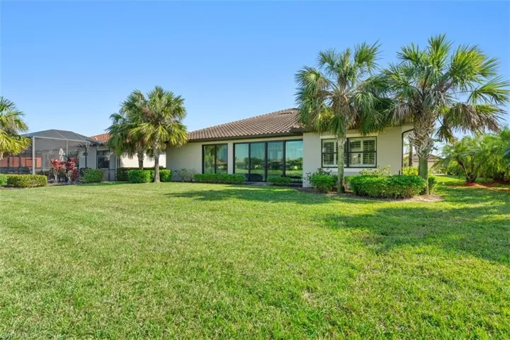 Back of property featuring a yard