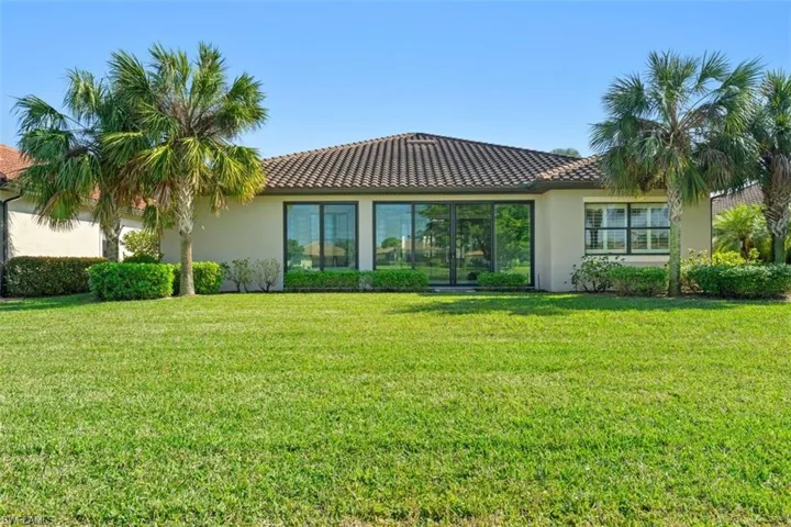 Back of house with a yard