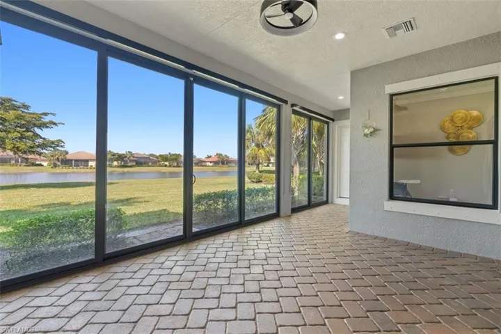 Unfurnished sunroom featuring a water view and a healthy amount of sunlight
