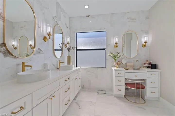 Bathroom with vanity and tile walls