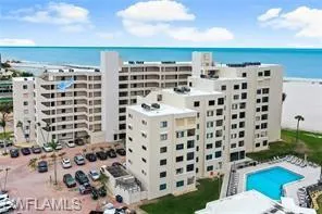View of apartment building / complex with a water view and a community pool
