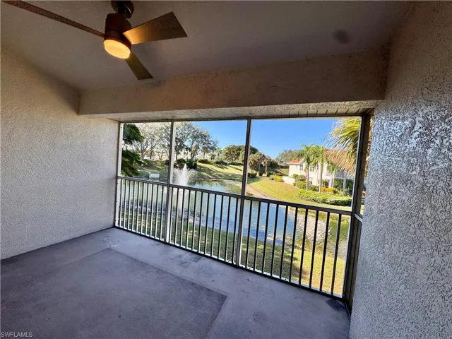 Balcony with a water view and ceiling fan