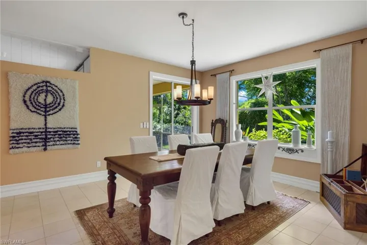 Tiled dining space featuring a chandelier