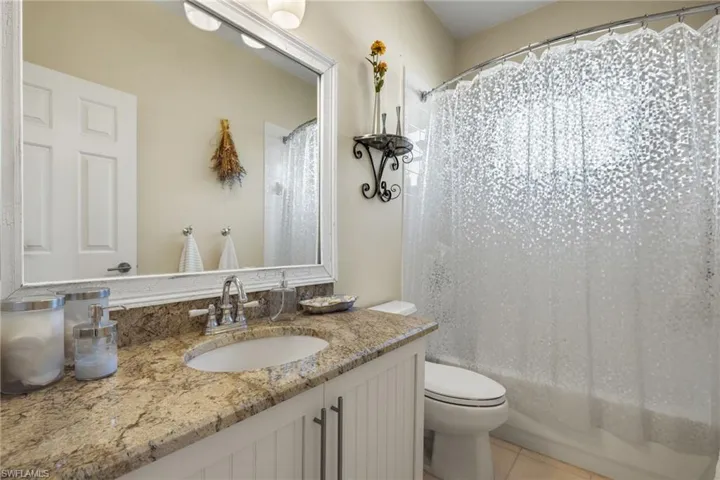 Bathroom featuring tile patterned floors, vanity, and toilet