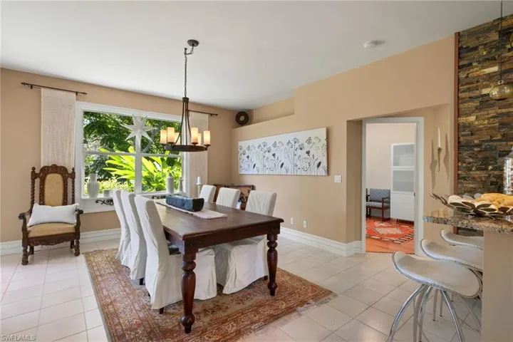 Tiled dining room with an inviting chandelier