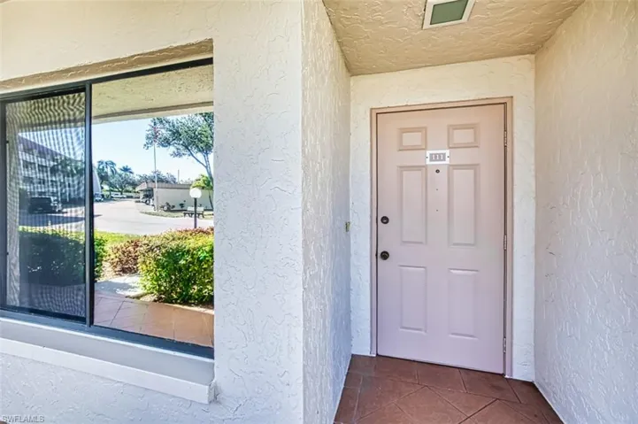 View of exterior entry featuring stucco siding