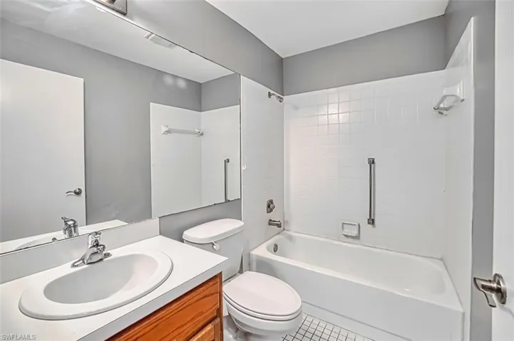 Bathroom featuring vanity,  shower combination, and light tile patterned floors