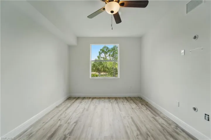 Unfurnished room with light wood-type flooring and ceiling fan