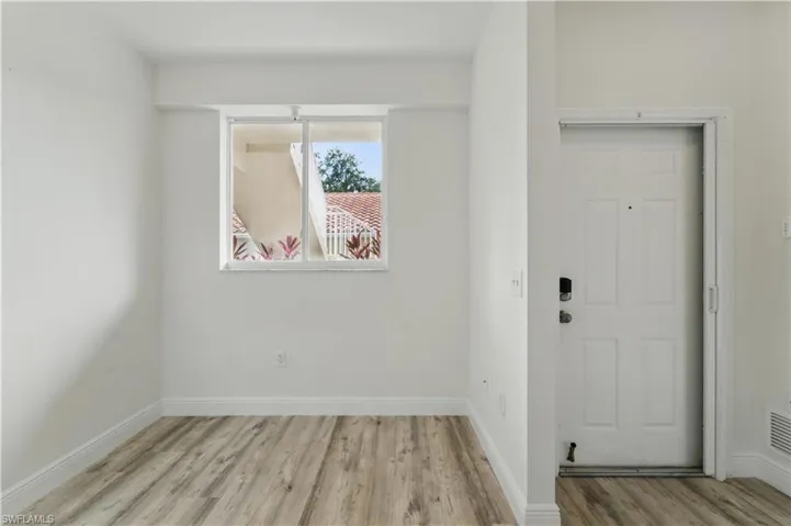 Foyer entrance featuring wood finished floors and baseboards