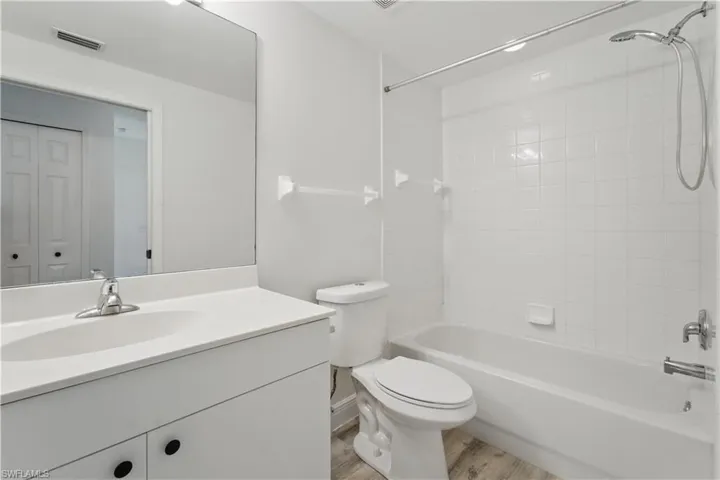 Full bathroom featuring vanity, shower / washtub combination, and wood finished floors