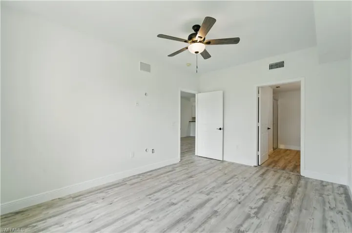 Unfurnished bedroom with light wood-style floors and a ceiling fan