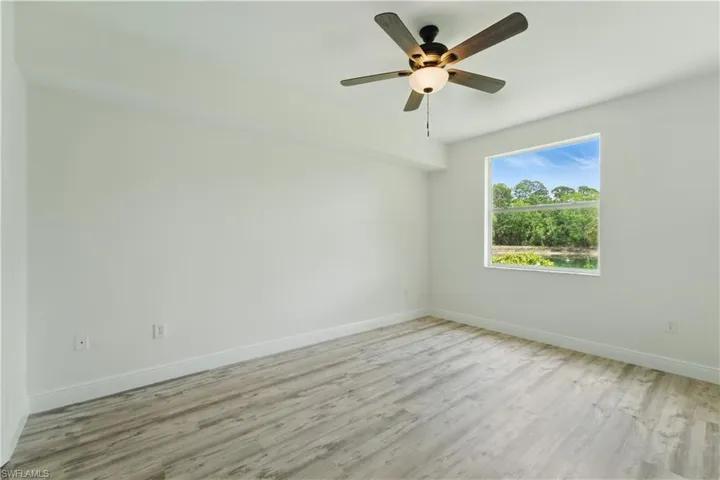 Spare room with light wood-type flooring and ceiling fan