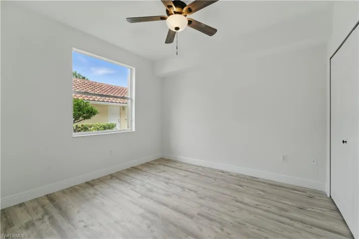 Empty room with light wood-type flooring and ceiling fan