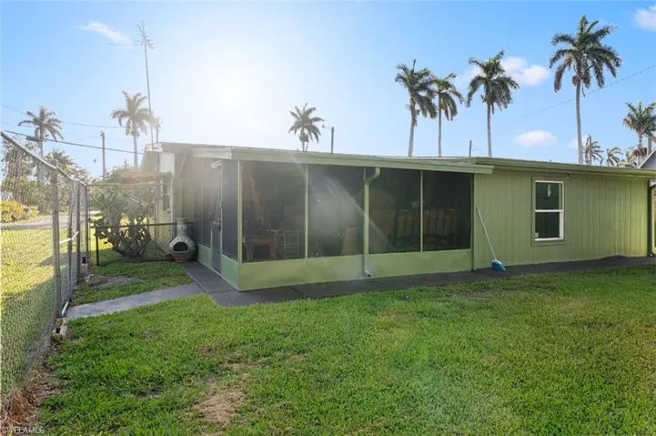 Rear view of house with a sunroom