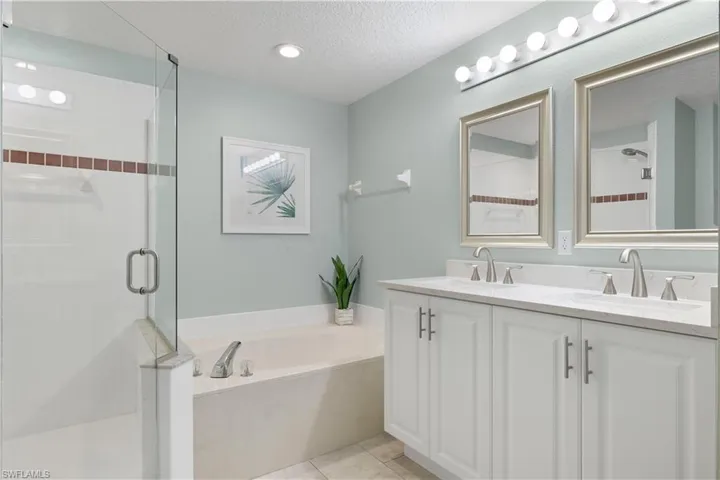 New Cabinetry, Toilet, and Glass Shower Enclosure