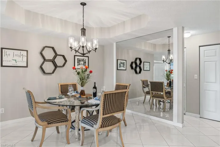 Family Dining Area with Chandelier and Mirrored Wall