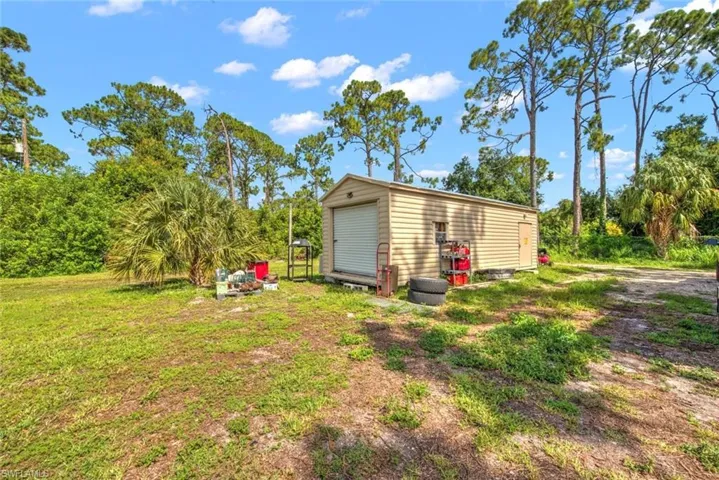 View of outbuilding with a yard