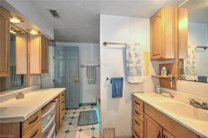 Bathroom with tile patterned flooring and vanity