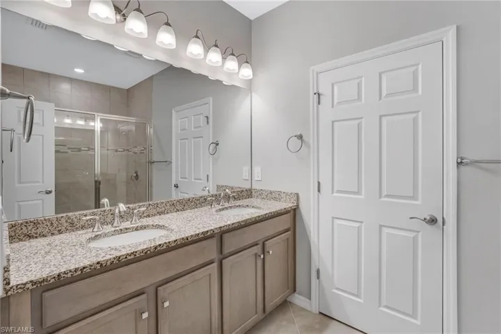Dual sinks with granite countertops add function and style to the primary bath.