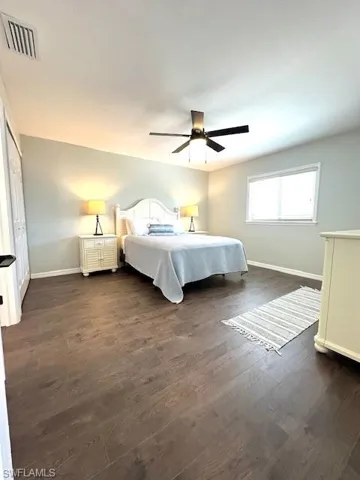 Master Bedroom with dark luxury vinyl finished floors, baseboards, ceiling fan, and visible vents
