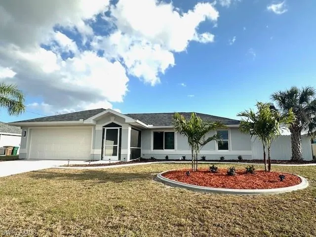Ranch-style home featuring stucco siding, concrete driveway, a front lawn, and an attached garage