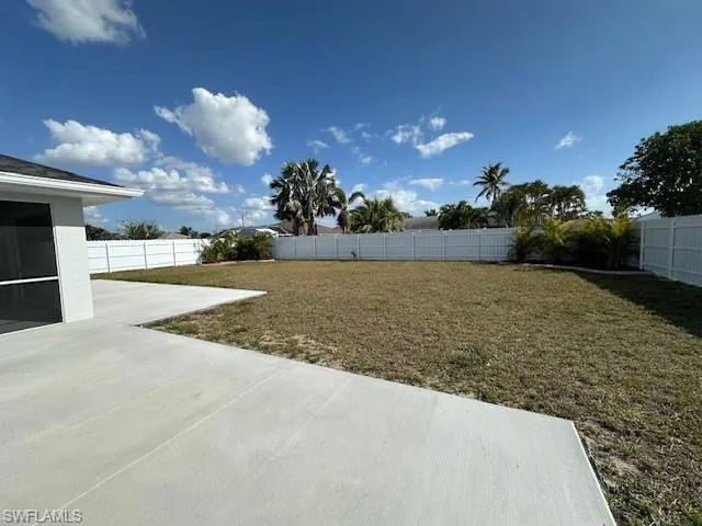 View of yard featuring a fenced backyard and a patio