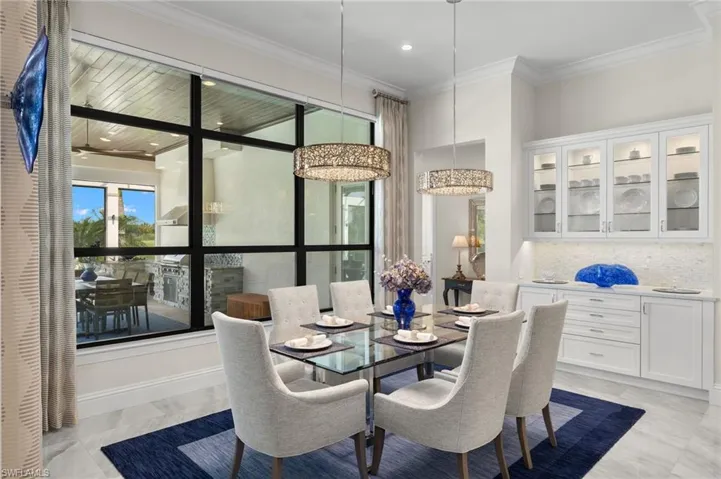 Dining space featuring crown molding and decorative light