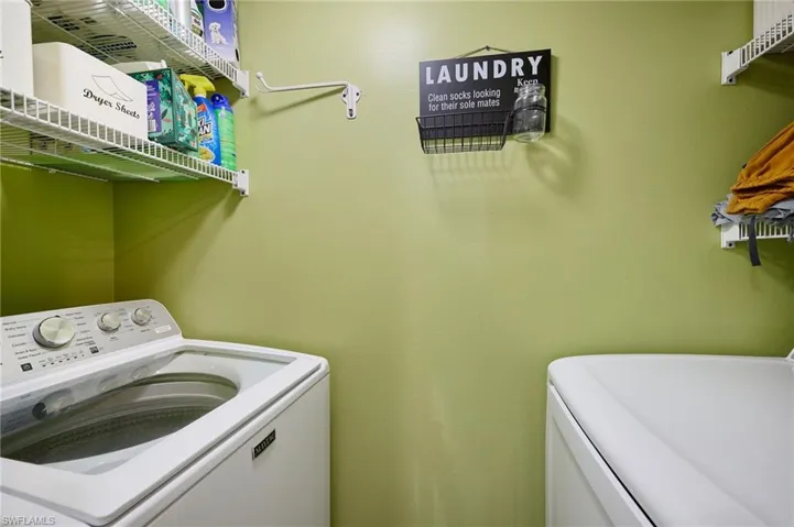 Washroom with washer and clothes dryer