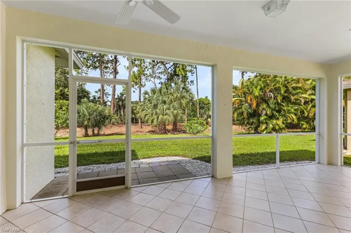 Unfurnished sunroom featuring ceiling fan