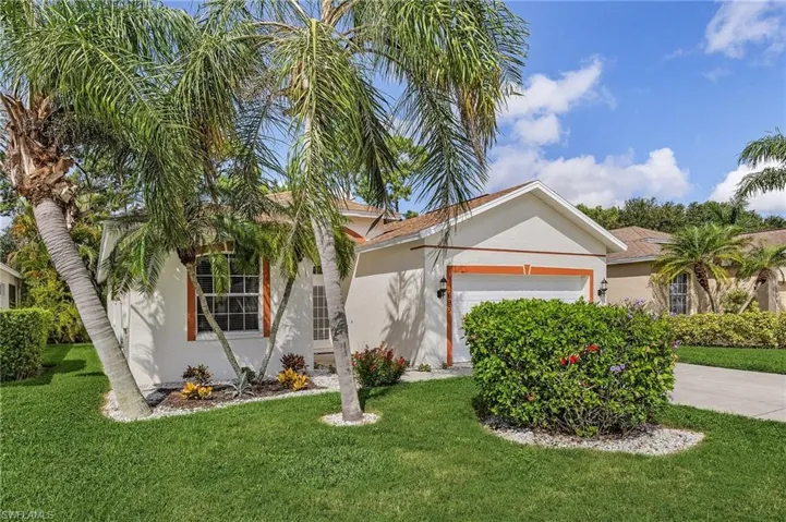 View of front of property with a front lawn and a garage