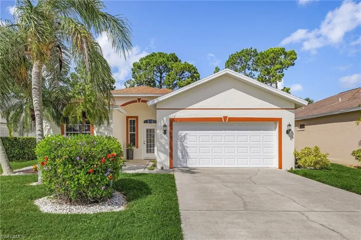 View of front of house with a garage and a front lawn