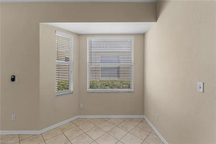 Empty room featuring light tile patterned floors