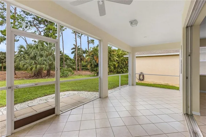 Unfurnished sunroom with ceiling fan