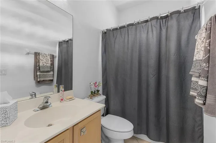 Bathroom featuring vanity, toilet, and tile patterned floors