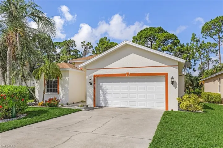 Single story home with a front yard and a garage