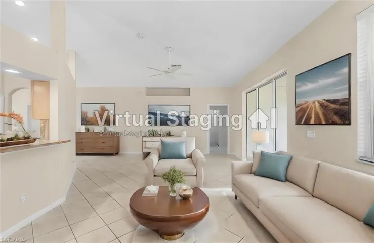 Tiled living room with ceiling fan and vaulted ceiling