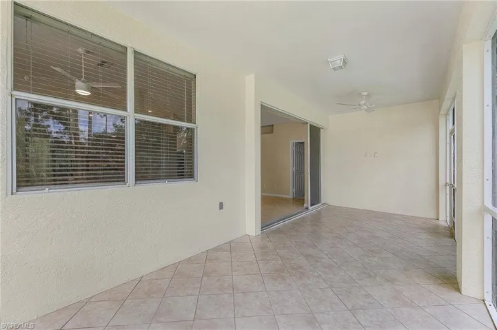 Unfurnished room featuring light tile patterned floors and ceiling fan