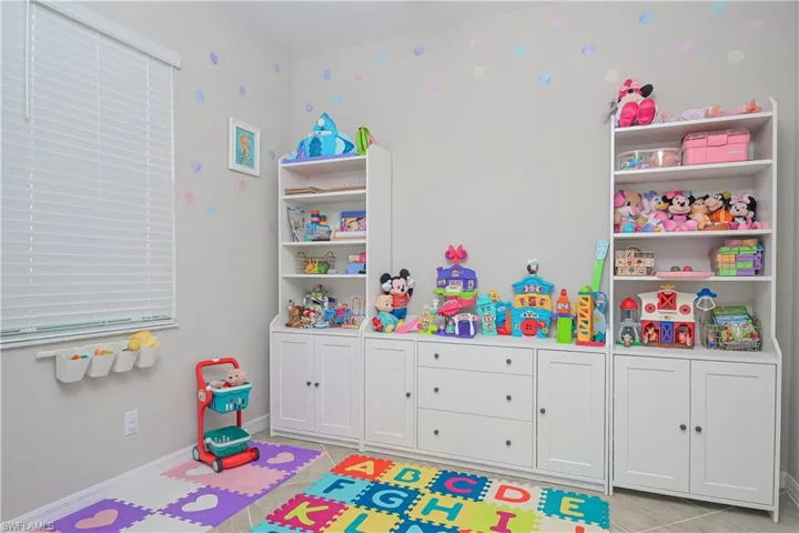 Game room featuring light tile floors