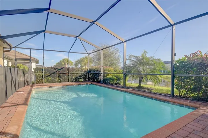 View of pool featuring glass enclosure