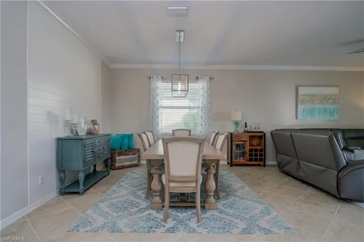 Tiled dining space with crown molding