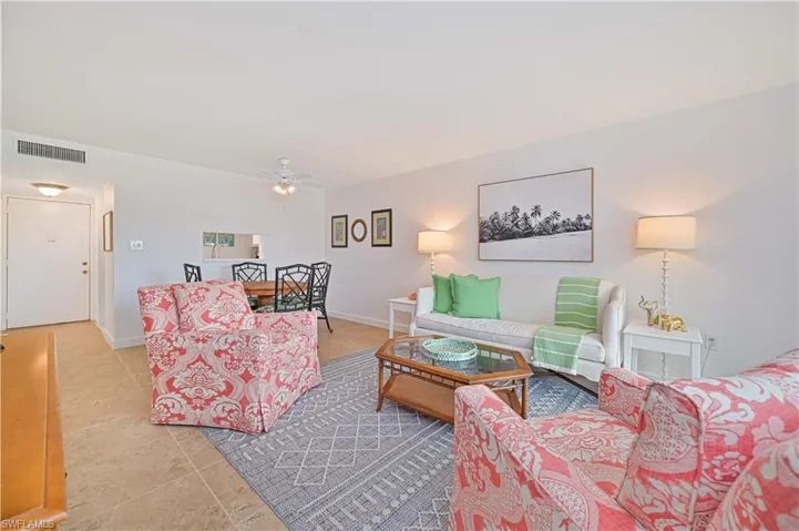 Living room featuring tile patterned flooring and ceiling fan